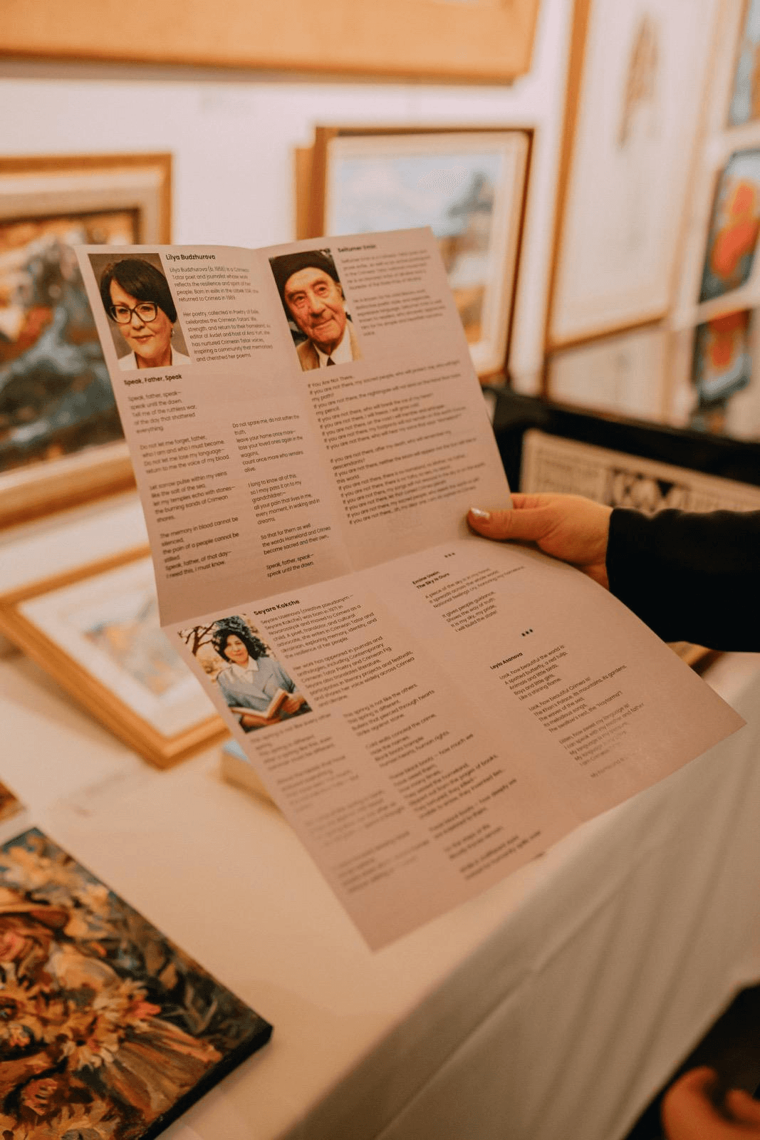 A visitor reading a bilingual cultural and literary programme.