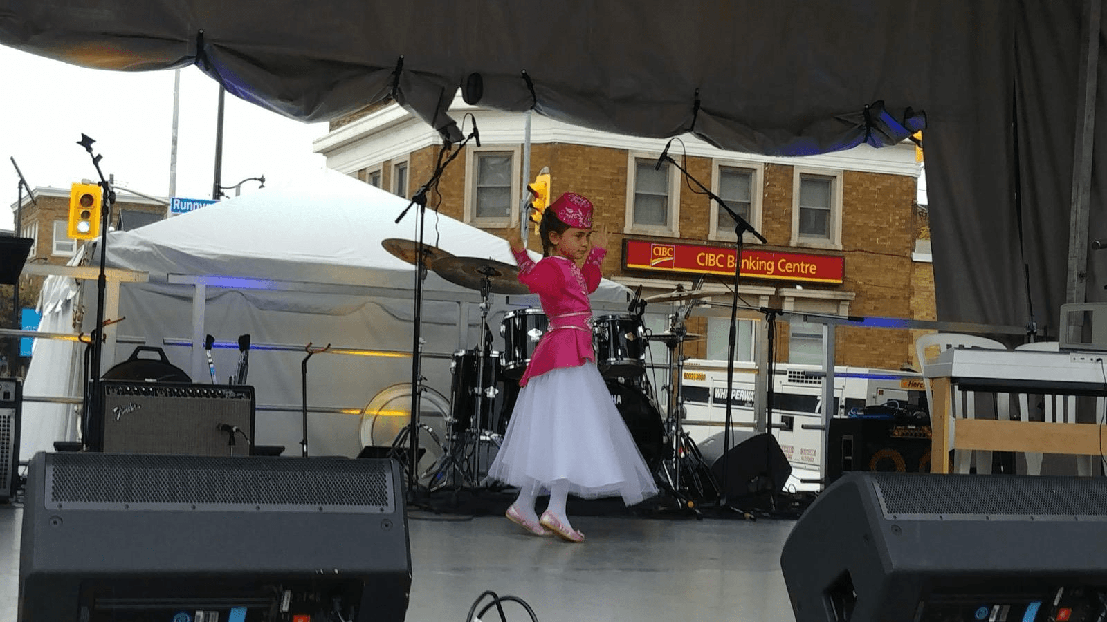 A young dancer performing at a community cultural festival.