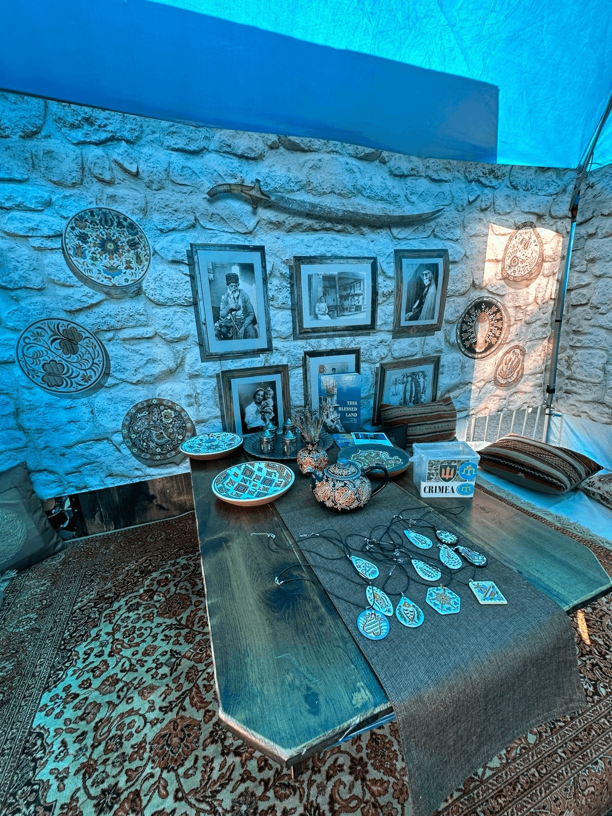 A display of Crimean Tatar ceramics, photographs, textiles, and jewellery.